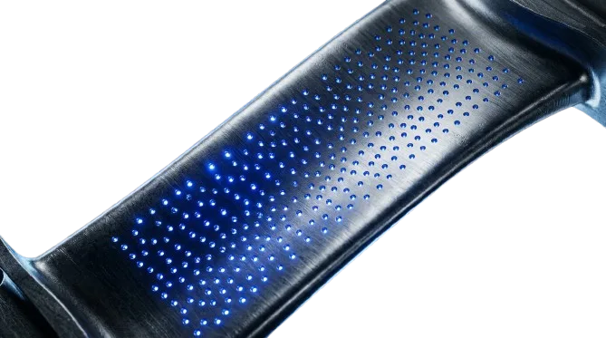 Array of small EDM-drilled cooling holes in a curved metal blade